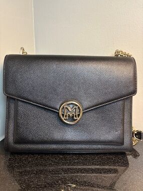 Metro City Pebbled Leather Shoulder Bag with Gold Emblem - Black